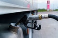 A close-up of a gas station gun inserted into the fuel tank. Royalty Free Stock Photo