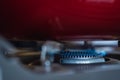 Close up gas stove with blue flames of burning gas with red pan Royalty Free Stock Photo