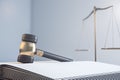 Close up of gavel, book and scales on light mock up backdrop. Law and jurisdiction concept. 3D Rendering Royalty Free Stock Photo