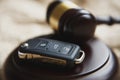 Close-up Of Gavel And Car Key On Sounding Block Against Grey Background Royalty Free Stock Photo