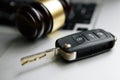 Close-up Of Gavel And Car Key On Sounding Block Against Grey Background Royalty Free Stock Photo