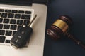Close-up Of Gavel And Car Key On Sounding Block Against Grey Background Royalty Free Stock Photo