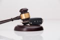 Close-up Of Gavel And Car Key On Sounding Block Against Grey Royalty Free Stock Photo