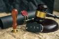 Close-up Of Gavel And Car Key On Sounding Block Against Grey Background Royalty Free Stock Photo
