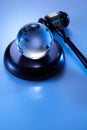 gavel hammer and glass globe on Asia and Africa against blue background Royalty Free Stock Photo