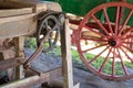 Close-up of gears on a vintage cider press with old wagon in the background Royalty Free Stock Photo