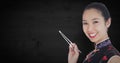 Close up of geisha with chopsticks against dark wood panel Royalty Free Stock Photo