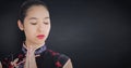 Close up of geisha with hands together against navy chalkboard Royalty Free Stock Photo