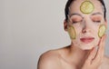 Close up gentle sophisticated calm girl in a moisturizing mask with a fresh cucumber on the face Royalty Free Stock Photo