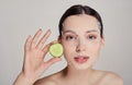 Close up gentle sophisticated calm girl in a moisturizing mask with a fresh cucumber on the face Royalty Free Stock Photo