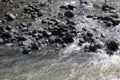 Close up of water flowing over slippery, wet pebbles at Ho\'olawa Stream in Haiku, Maui on the road to Hana