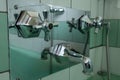 Close up of genuine original green vintage retro 1930s deco stainless steel bath shower taps. Royalty Free Stock Photo