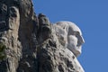 Close up of George Washington`s head on Mount Rushmore with blue sky