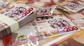 close up of 200 Ghanaian cedi notes spread on table. money scattered on surface Royalty Free Stock Photo