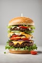 Close-up of giant delicious fresh cheeseburger on grey background