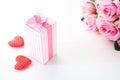 Close up gift box on white background with pink roses and heart on white