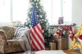 Close-up of gift boxes and a Christmas tree with an American flag in the background. Space for text. Concept of Royalty Free Stock Photo