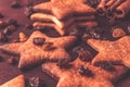 Close up of ginger cookies in the shape of a star with raisins on a red wood Royalty Free Stock Photo