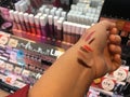 Close up A girl arm test lips tester all color at Maybelline shelf store from sup