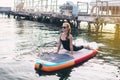 Close-up of a girl doing yoga on sub board. Psychology meditation, relaxation and self-healing concept. Lonely woman alone on