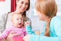 Girl feeding her brother baby with spoon