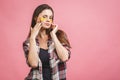 Close-up of a girl with gold patches under eyes from swelling and wrinkles. Isolated on pink background Royalty Free Stock Photo