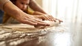 Close up of girl and grandmother rolling out dough Royalty Free Stock Photo