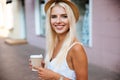 Close up of girl in hat holding take away cup Royalty Free Stock Photo