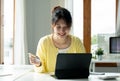 Close up of girl hold bank credit card, shopping online using mobile phone, buying goods or ordering online, entering Royalty Free Stock Photo