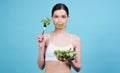 Close-up, the girl is holding an avocado with the inscription keto