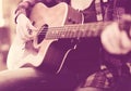 Girl holding guitar. Focus on strings of guitar Royalty Free Stock Photo