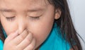 Close up of a girl holding her nose because of a bad smell. Royalty Free Stock Photo