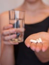 Close Up Of Girl holding Pill and glass of water.With Paracetamol.Nutritional Supplements.Sport,Diet Concept.Capsules Vitamin And Royalty Free Stock Photo