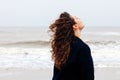 Girl rain sea wind winter portrait woman smile spring coat long hair curly mood shore snow beach Royalty Free Stock Photo