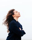 Girl rain sea wind winter portrait woman smile spring coat long hair curly mood shore snow beach Royalty Free Stock Photo