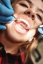 Your pathway to a bright new smile. Teen at the dental office. Dentist examining girl`s teeth in clinic.