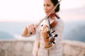 Close-up of a girl playing the violin.