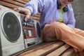 Close up of girl pressing button on old school boombox playing music urban Royalty Free Stock Photo