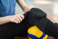 Close up of a girl puts on kneecaps for volleyball training Royalty Free Stock Photo