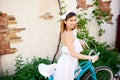 Close-up of girl in romantic image holding vintage bicycle