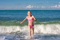 Close-up girl running from sea wave or surf Royalty Free Stock Photo