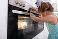 Close-up Of Girl`s Hand Touching Electric Oven