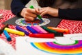 Close-up of girl`s hands coloring a mandala