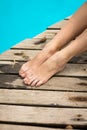 Close-up of a girl`s legs resting near the pool Royalty Free Stock Photo