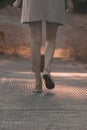 Close-up of a girl strolling along a wooden bridge.