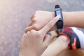 Close up Girl using smartwatch touching button and touchscreen on active sports. Finger touch button on smarth watch. Girl set Royalty Free Stock Photo