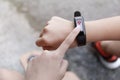 Close up Girl using smartwatch touching button and touchscreen on active sports. Finger touch button on smarth watch. Girl set Royalty Free Stock Photo