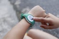 Close up Girl using smartwatch touching button and touchscreen on active sports. Finger touch button on smarth watch. Girl set Royalty Free Stock Photo