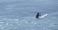 A girl waiting for waves with a sufboard Royalty Free Stock Photo