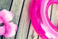 Close-up girl or woman empty glamour fashion fluffy fuzzy slippers and inflatable float ring on wooden floor background Royalty Free Stock Photo